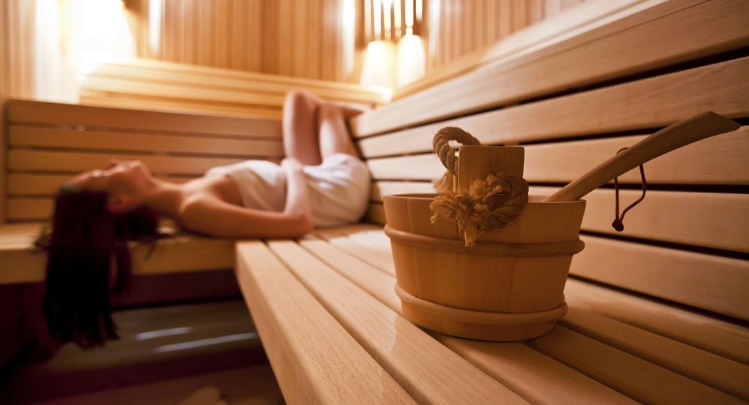 Woman lying down at Wooden Infrared Sauna