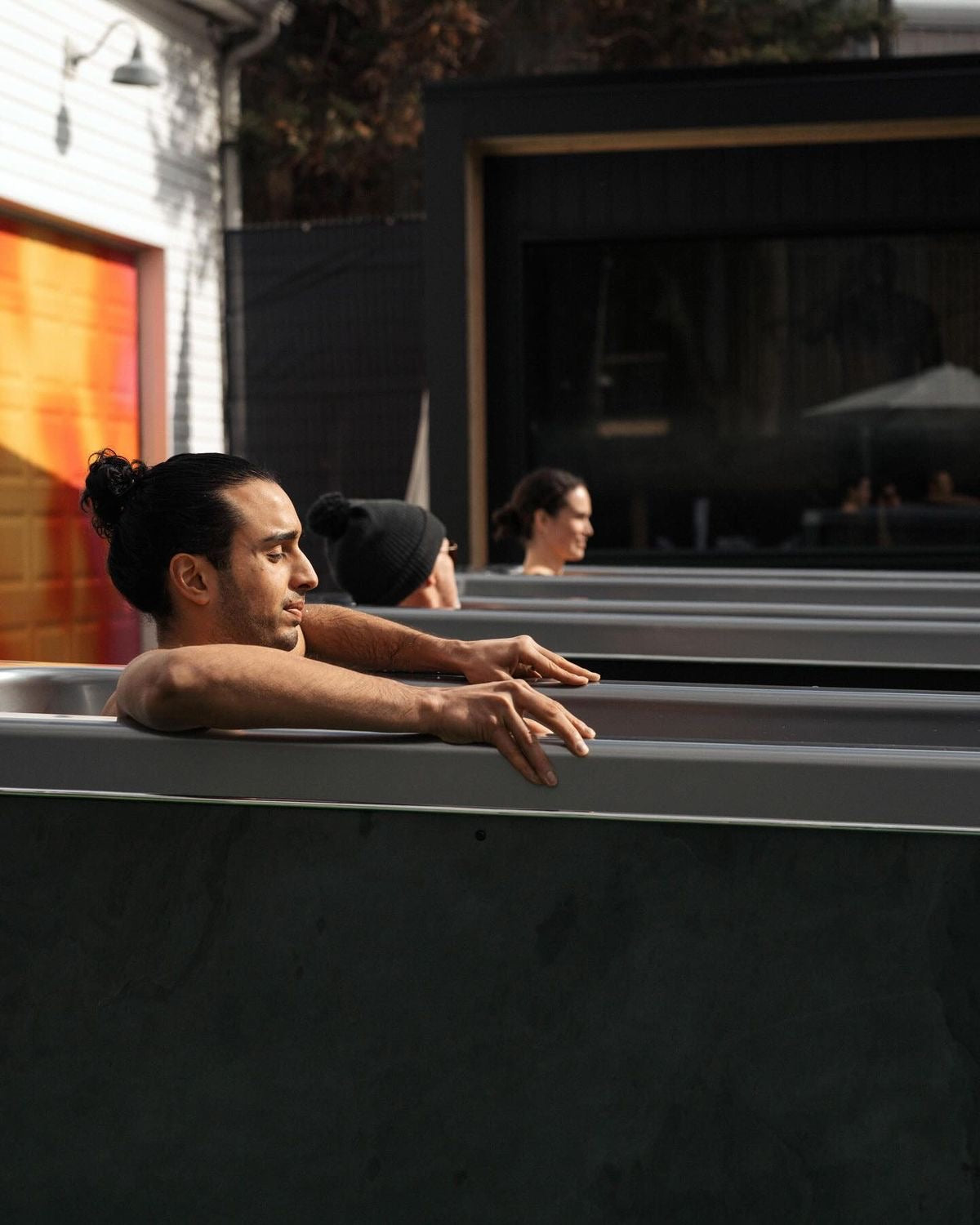 People in Cold Plunge Tubs Outside