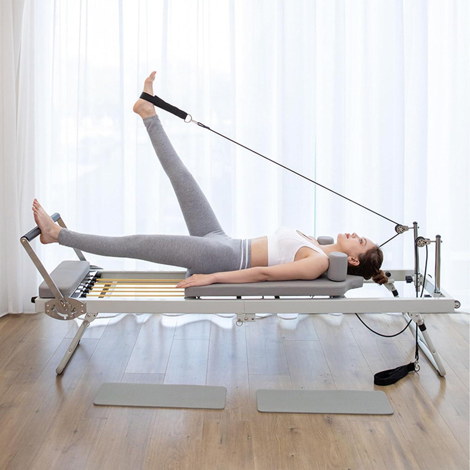 Person using a Pilates reformer machine demonstrating full body extension and carriage length