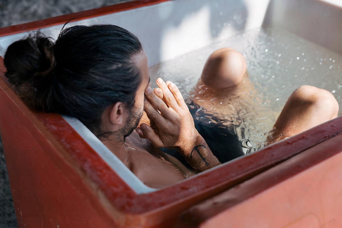 Man in Ice Bath Tub in The shower