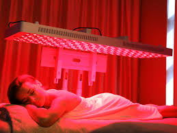Woman in Bed with Red Light Therapy Panels