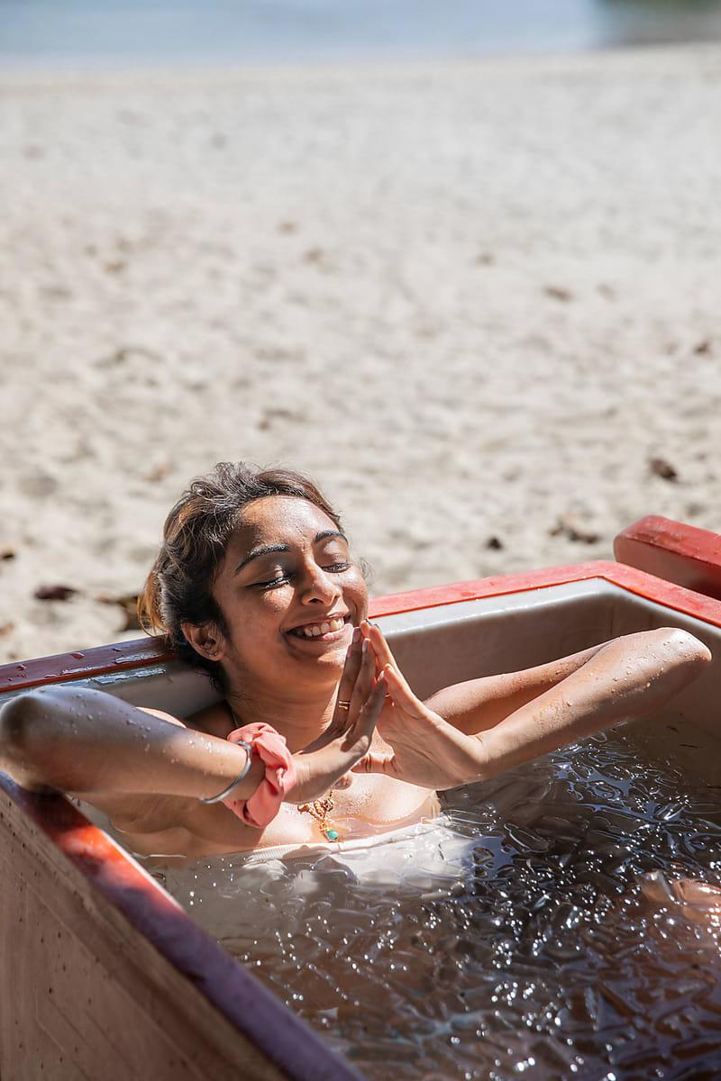 woman submerge inside a cold plunge tub