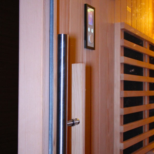 Sauna glass door handle and digital control panel mounted on wooden wall.
