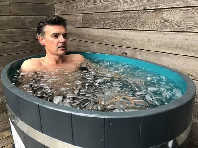 man in Cold Plunge Tub vs ice