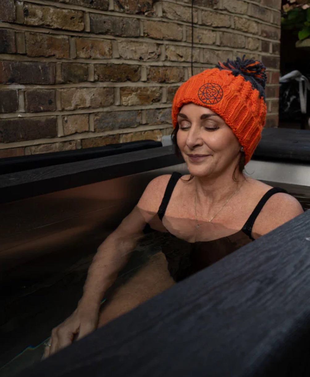 Woman rejuvenating in cold plunge tub 