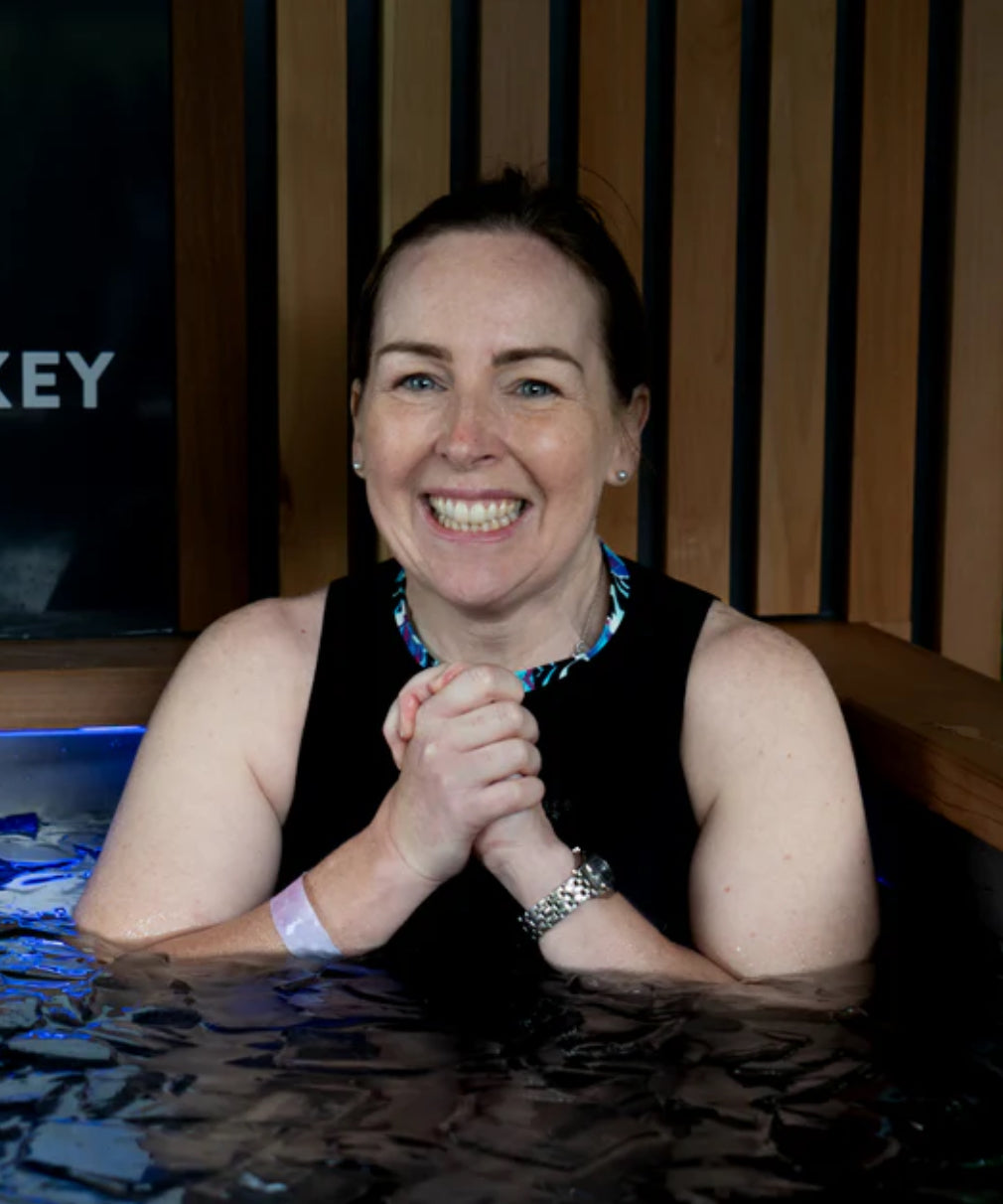 Happy Woman dipped in the cold plunge water