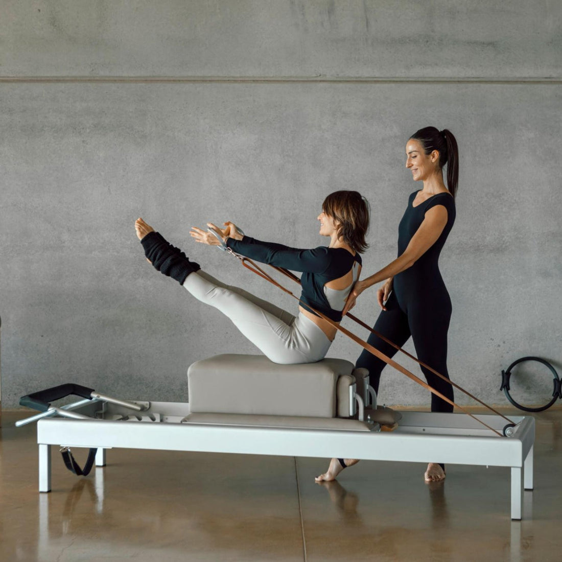 Woman doing core exercises during Personal Pilates class on a Reformer machine.
