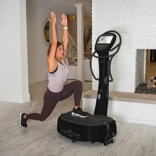 Woman exercising with Powerplate My7 at home
