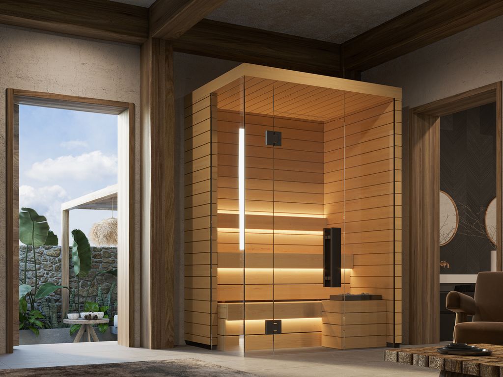 Kuut Modular Sauna Otto S with glass front and aspen wood interior, installed in a modern home with an open doorway and tropical outdoor view, on a stone and timber interior background.