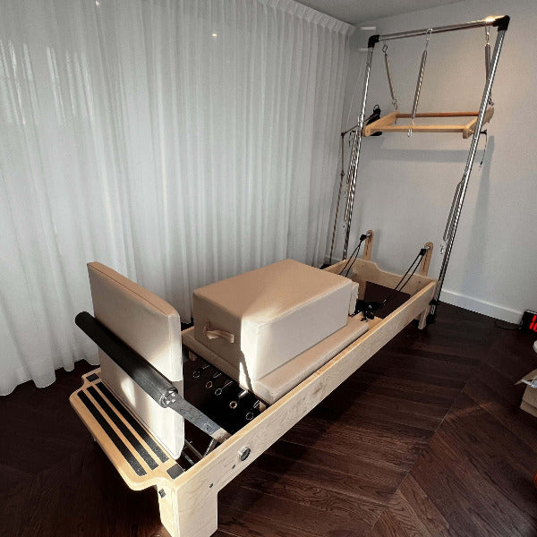 Atro Pilates Tower Reformer – beige upholstery reformer with full tower and footbar attachment