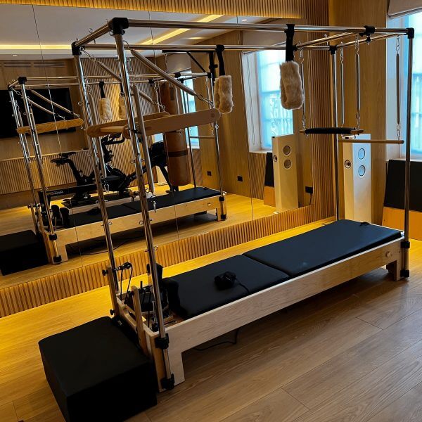 Atro Pilates Cadillac Reformer – studio setup with chrome frame and padded leather bed