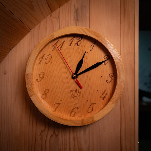 Wooden wall clock mounted inside hybrid barrel sauna