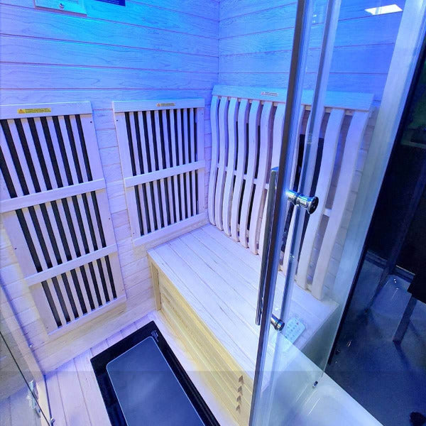 Interior bench and infrared panels inside Insignia KSY1820 sauna with blue lighting