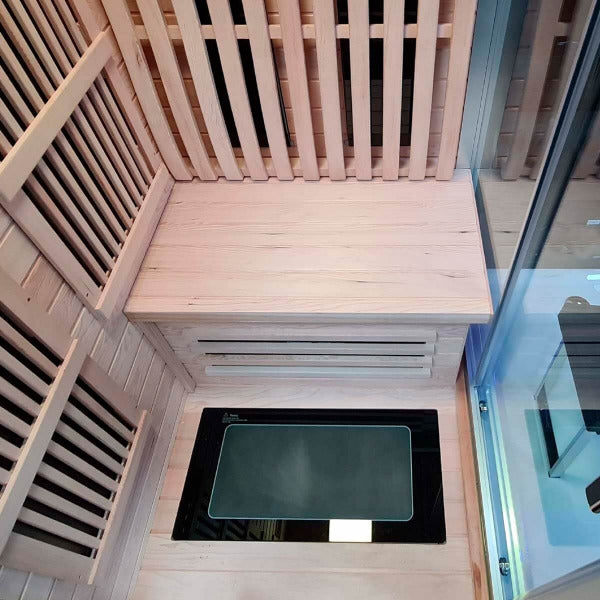 Wooden sauna bench and floor heater inside Insignia KSY1820 infrared cabin