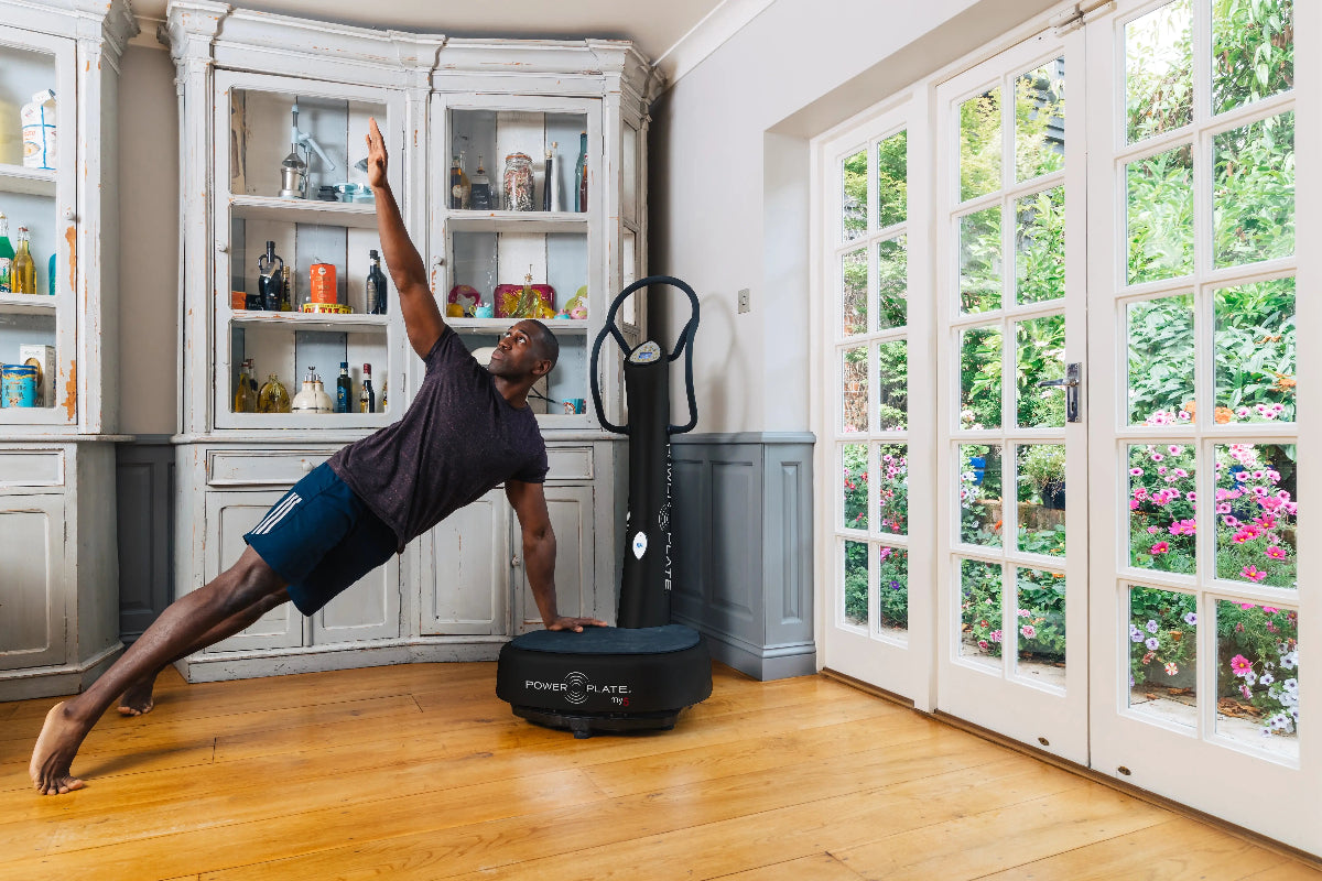 Man exercising with Powerplate MY5 in the living room