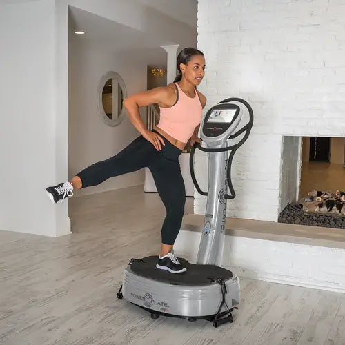 Woman exercising with Powerplate My7 at home
