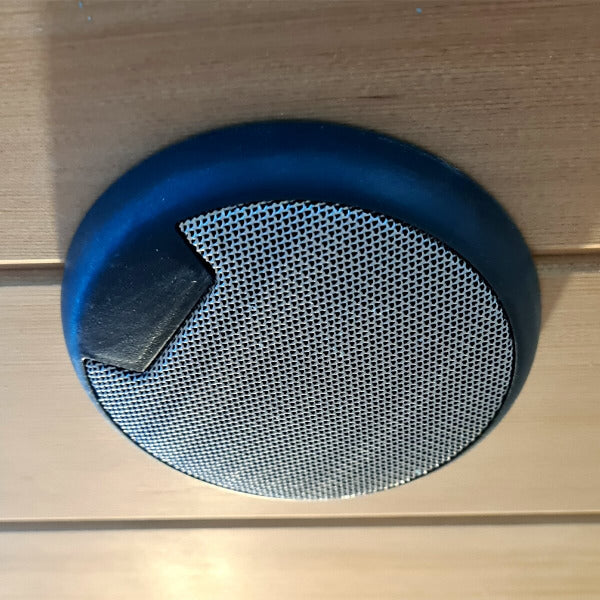 Built-in round speaker mounted on sauna wall for integrated audio experience