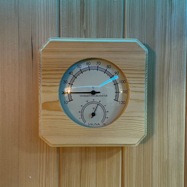 Wooden thermo-hygrometer showing temperature and humidity inside sauna