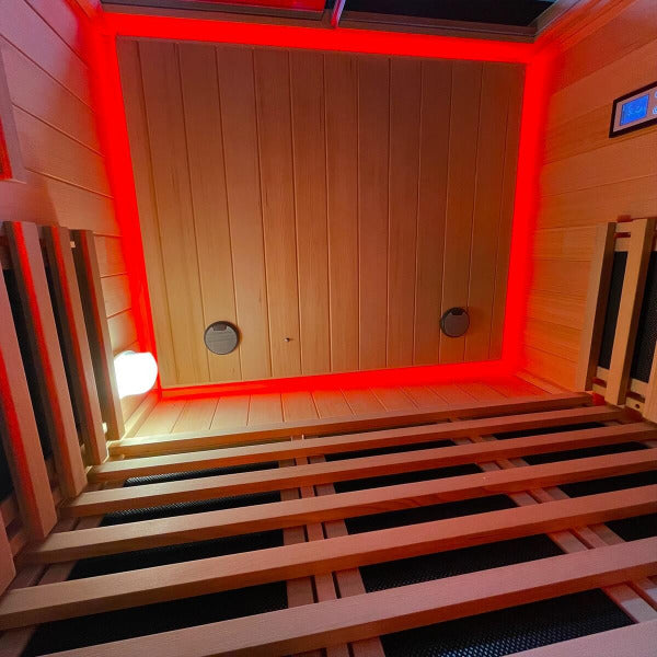 Infrared sauna ceiling with red LED chromatherapy lighting and wood finish