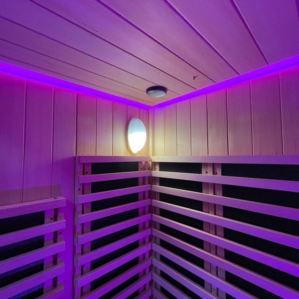Wooden sauna interior with wall lamp and red chromatherapy ceiling lighting